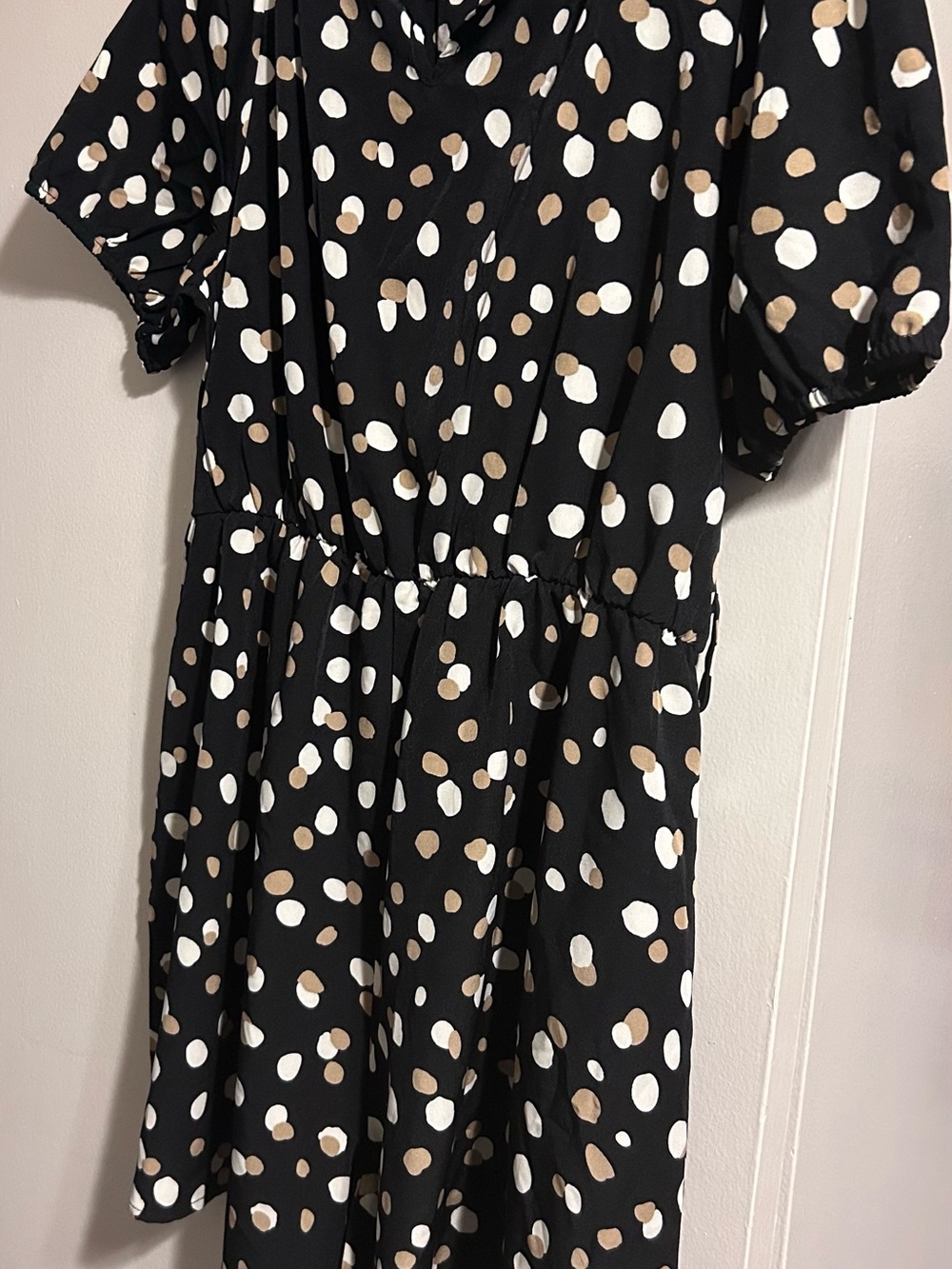 Black Polka Dot Short Sleeve Romper with White and Tan Spots.